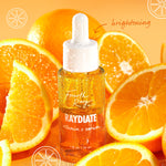 RAYdiate Vitamin C Serum by Fourth Ray Beauty (ColourPop Face Serum) displayed as a dewy dropper bottle beaded with condensation, standing among juicy orange slices on a bright orange backdrop, emphasizing a brightening, glow-boosting formula.