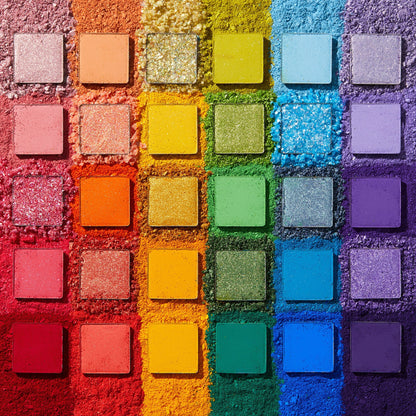 Fade Into Hue shadow palette displays 30 square pans in a rainbow grid - matte, shimmer, and pressed glitter - set on crushed pigment in a deconstructed flat lay; a vibrant ColourPop Shadow Palette.